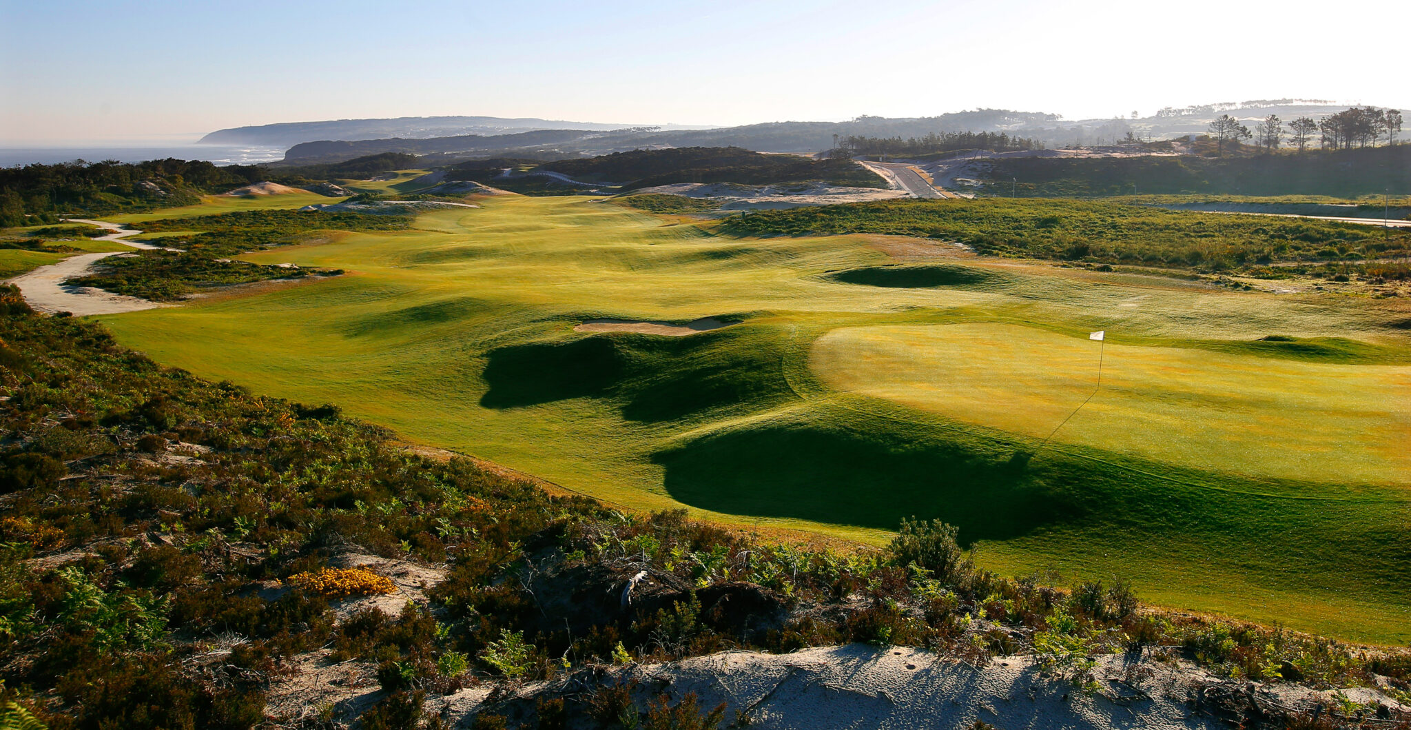 Hole with white flag and fairway at West Cliffs Golf Links