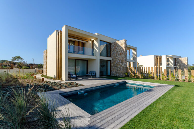 Exterior of accommodation and outdoor pool at West Cliffs Ocean Golf Resort