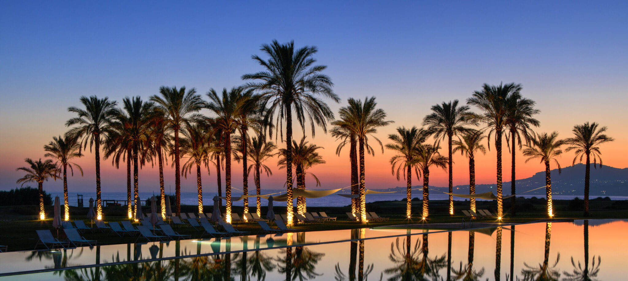 Verdura Resort Sicily, swimming pool sunset view.
