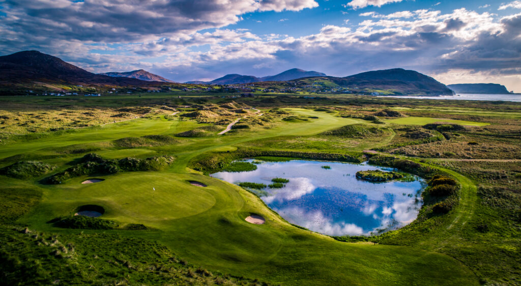 Hole with bunkers at Ballyliffin Golf Club - Old Links with a pond next to it