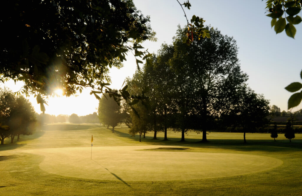 Hole with yellow flag and trees around at Best Western Ullesthorpe Golf Course