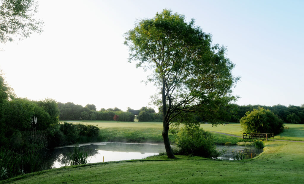 Fairway with water hazard and trees around at Best Western Ullesthorpe Golf Course