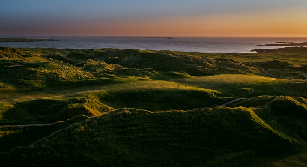 Aerial view of Carne Golf Links with ocean in distance