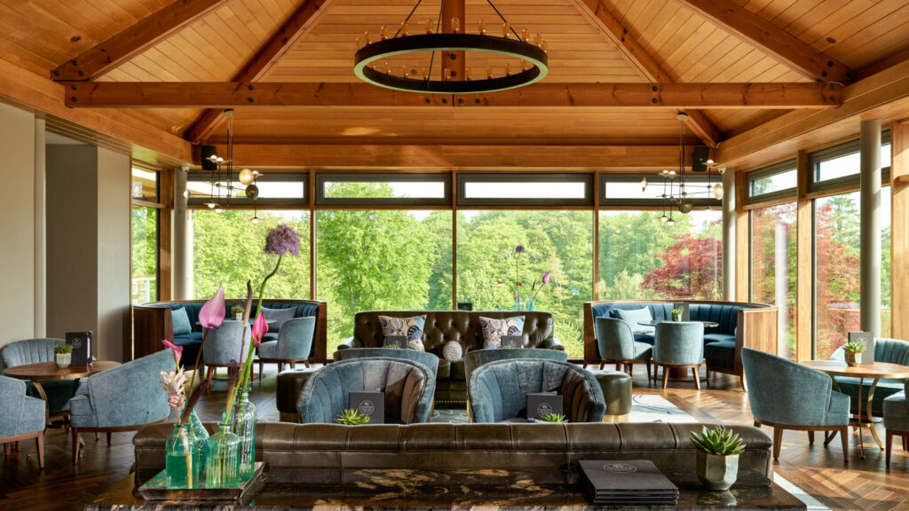 Indoor restaurant with view of the gardens at Druids Glen Hotel