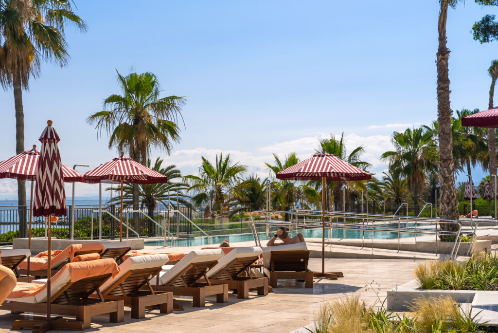 Sun loungers by outdoor pool at El Fuerte Marbella