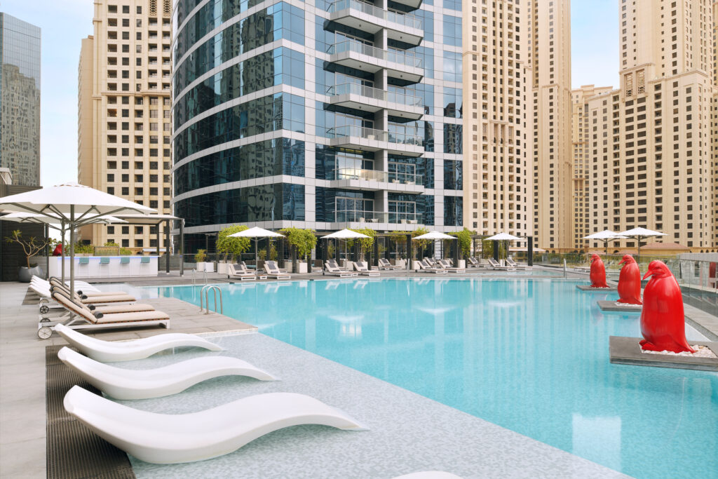 Outdoor pool at Intercontinental Dubai Marina with buildings around