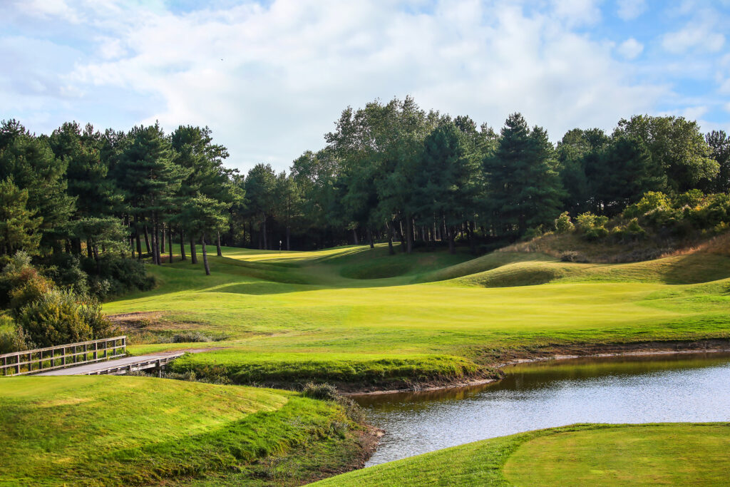 Lake on fairway at Belle Dune with trees around