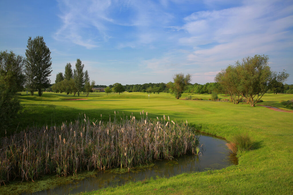 Fairway with water hazard and trees around at Belton Woods - Lakes Course