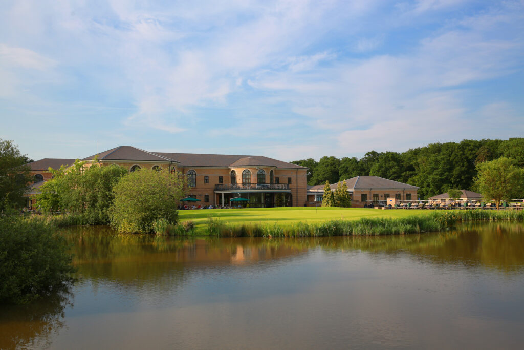 Lake with building in background at Belton Woods - Lakes Course