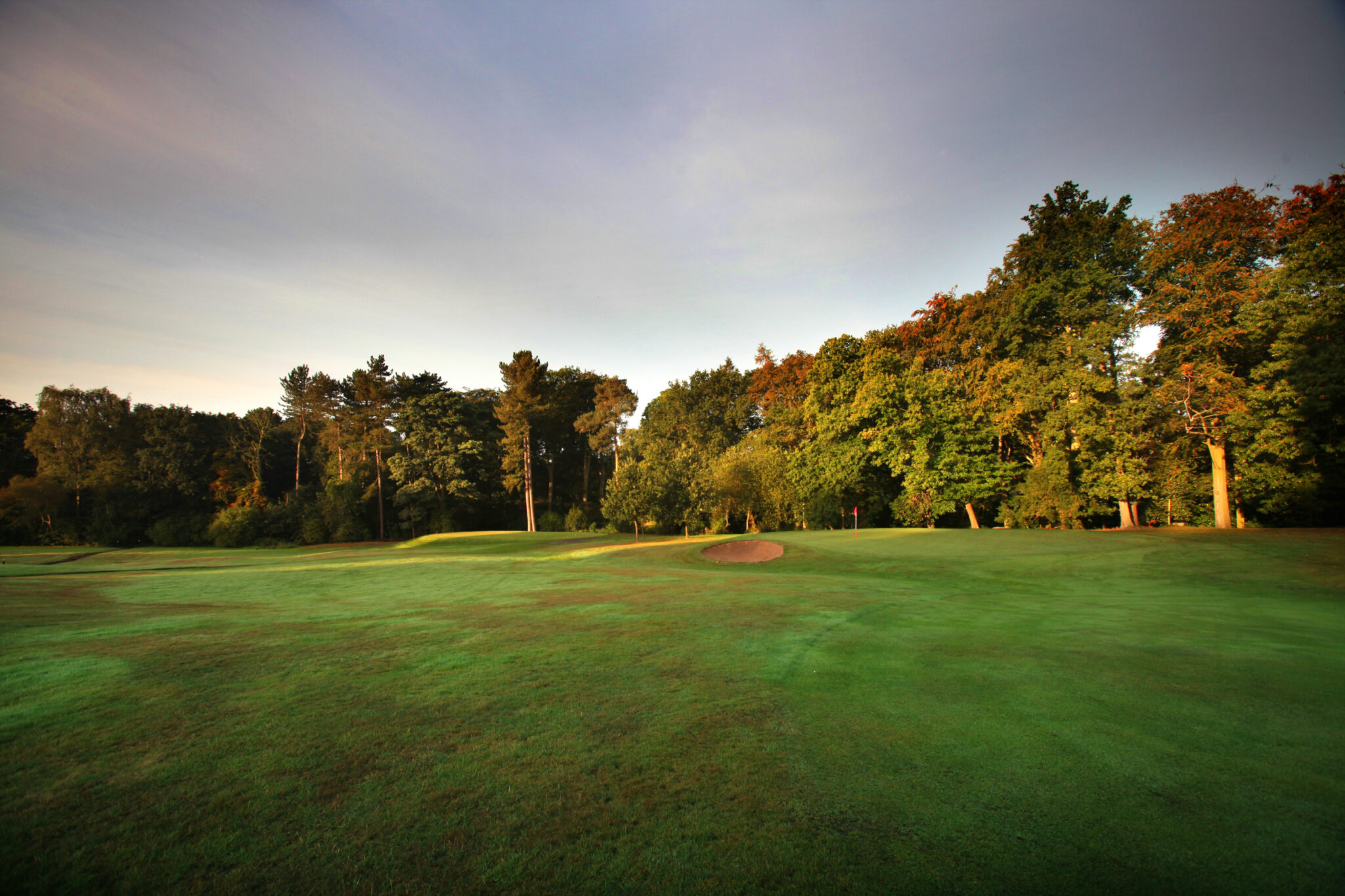 Fairway with bunker and trees around at Breadsall Priory - Moorland Course