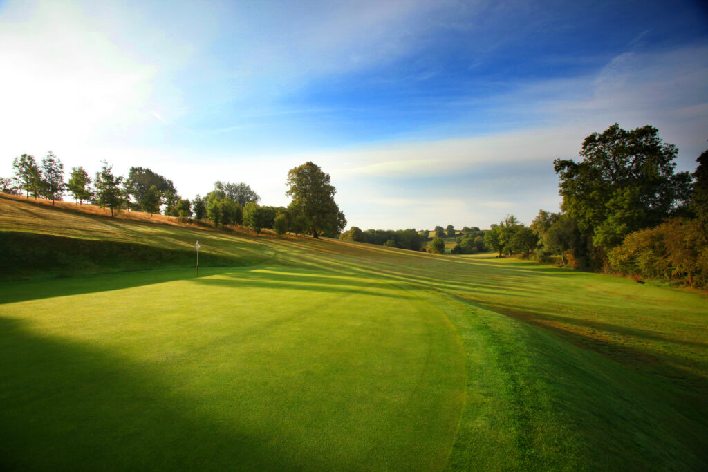 Hole with white flag at Breadsall Priory - Moorland Course with trees around