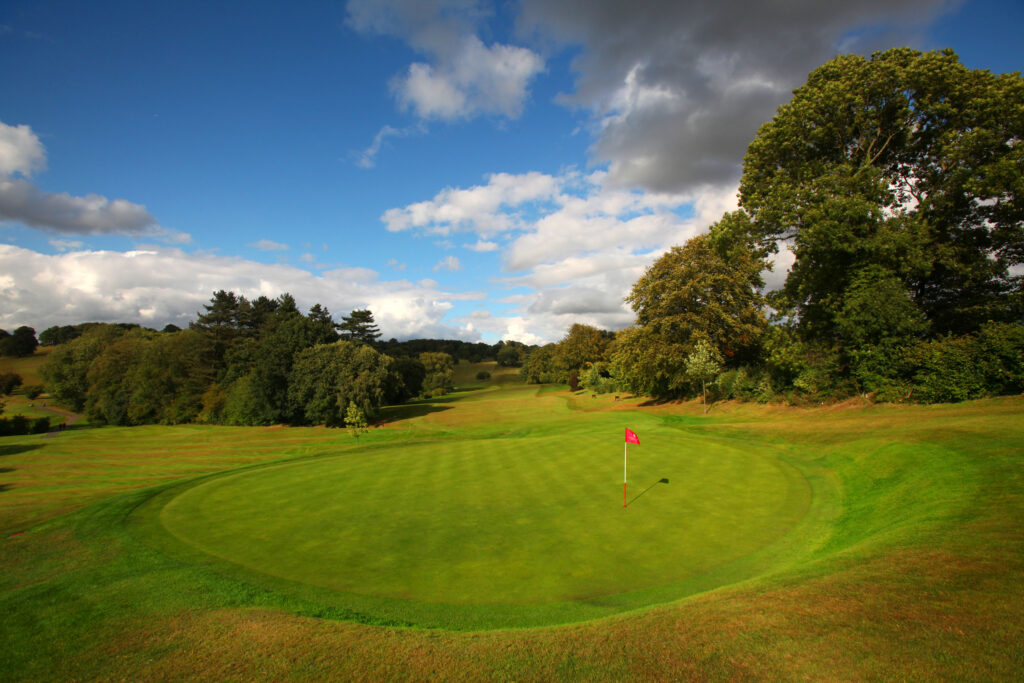 Hole with red flag and trees around at Breadsall Priory - Priory Course