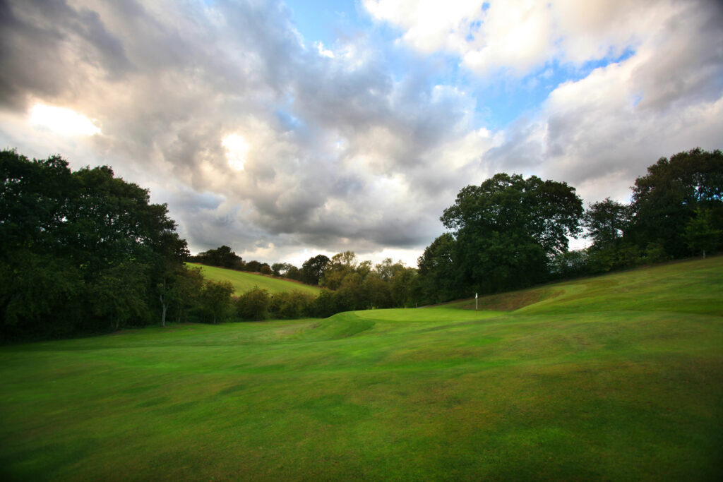 Hole with white flag at Breadsall Priory - Priory Course with trees around