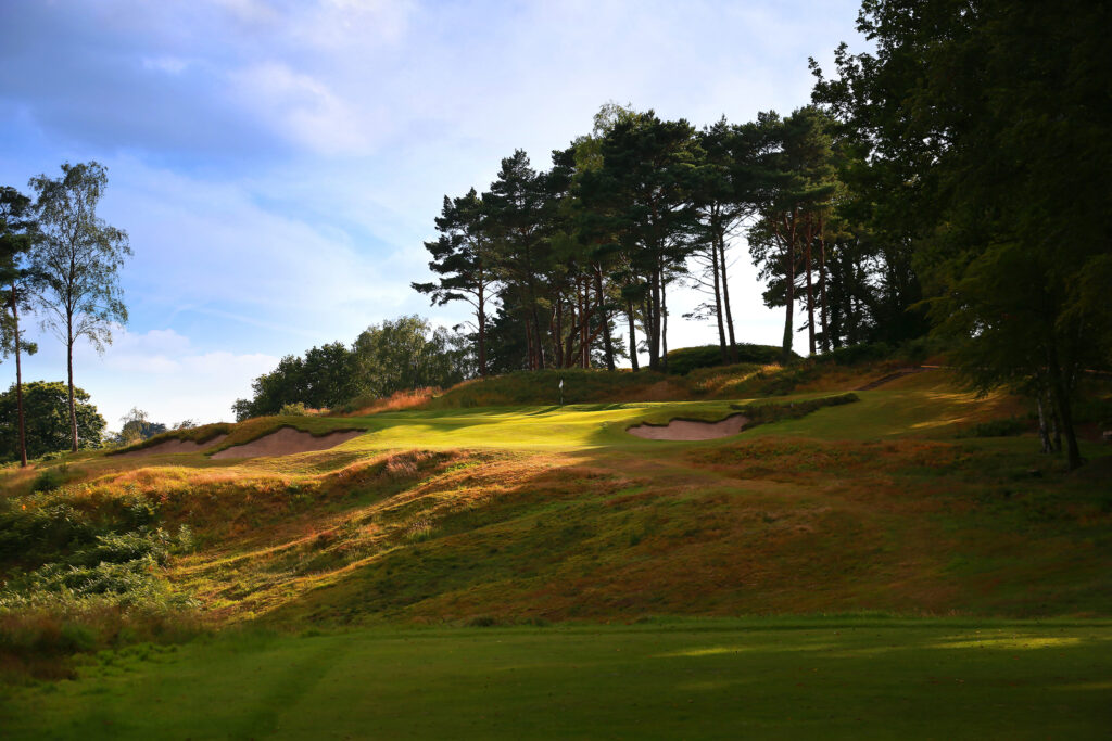 Fairway leading up to hole with bunkers and trees around at Broadstone Golf Club