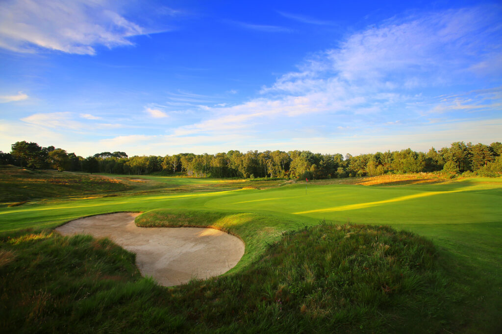 Hole with bunker and trees around at Broadstone Golf Club