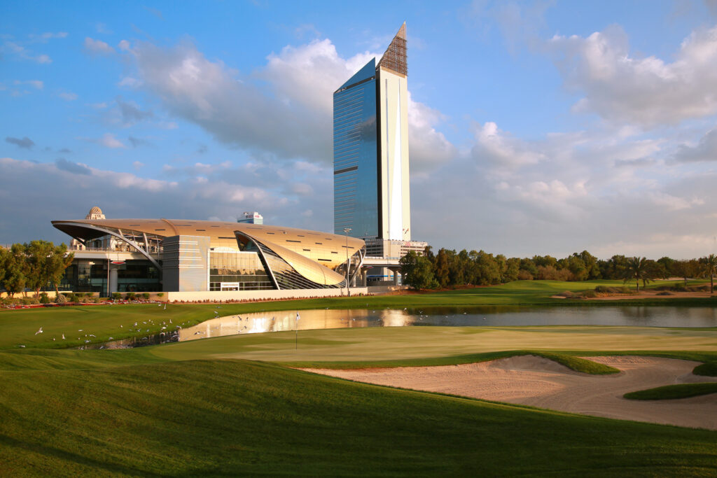 Hole with bunkers at Emirates Golf Club - The Faldo with buildings and lake in background