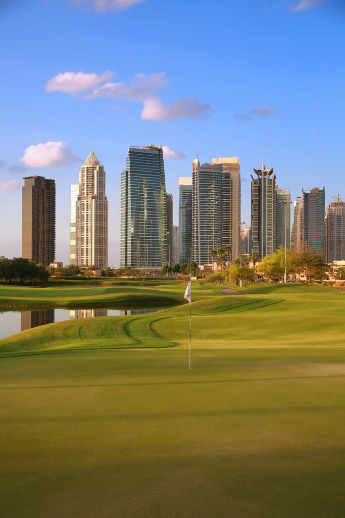 Hole with buildings in distance at Emirates Golf Club - The Faldo