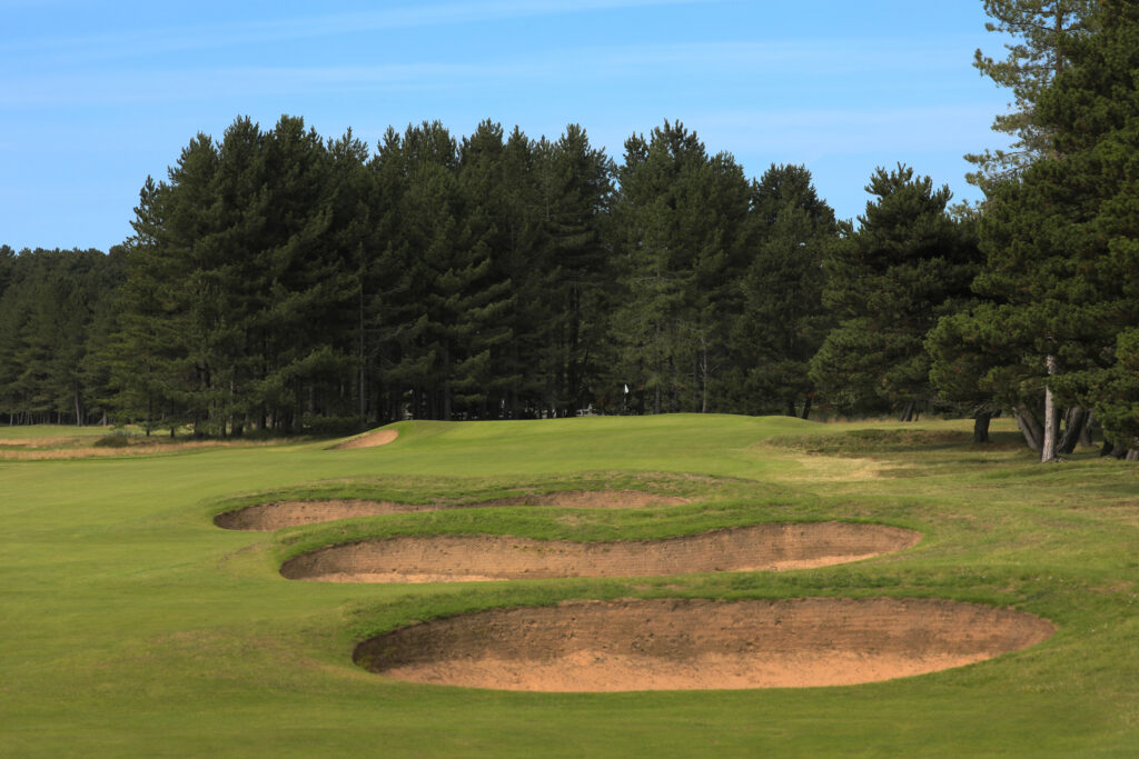 Hole with bunkers at Formby Golf Club with trees around