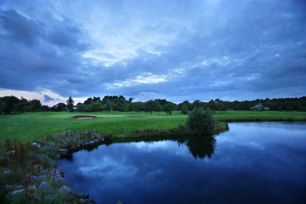 Lake on fairway with trees in background at Formby Hall - Championship Old Course