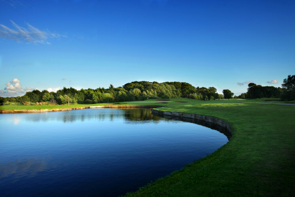 Lake on fairway with trees in background at Formby Hall - Championship Old Course