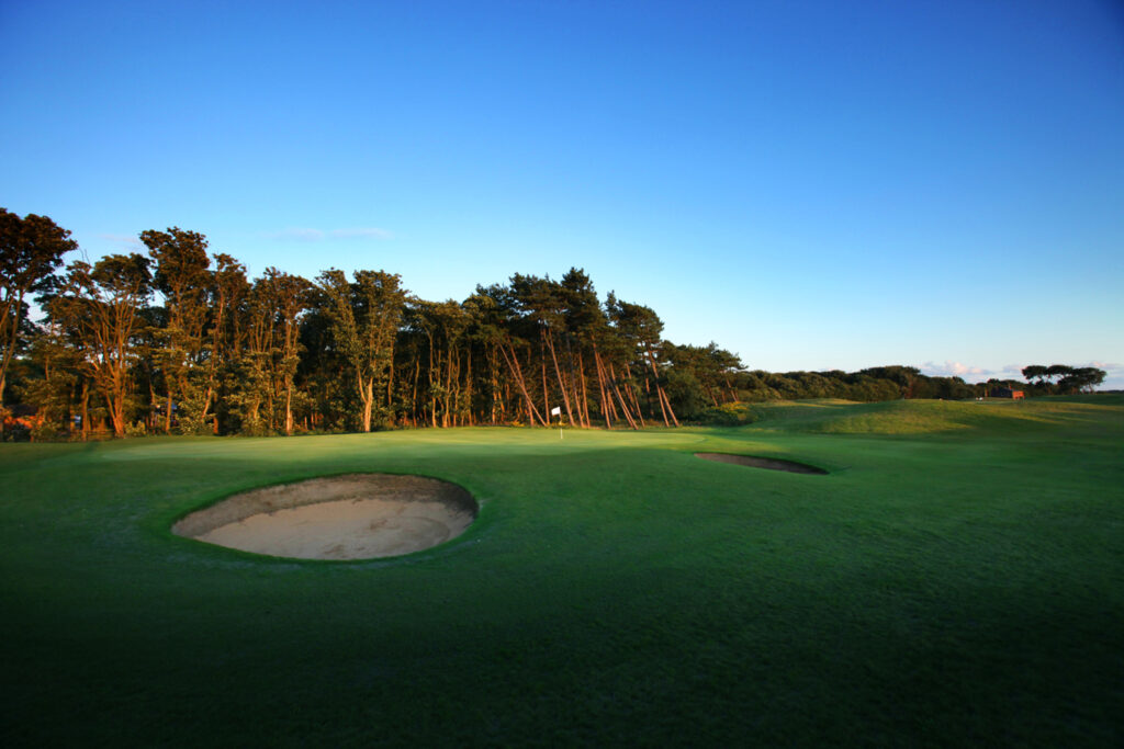 Hole with bunkers and trees in background at Formby Hall - Championship Old Course