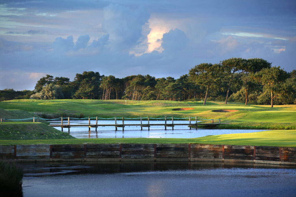 Fairway with bridge over lake at Formby Hall - Championship Old Course with trees in background