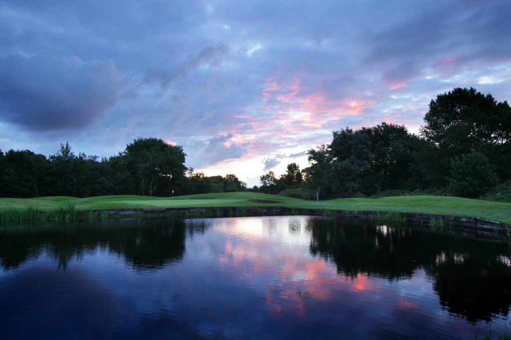 Lake on fairway with trees around at Formby Hall - Championship Old Course