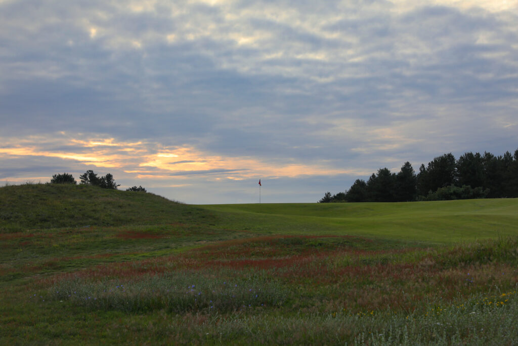 Hole with red flag at Formby Ladies Golf Club