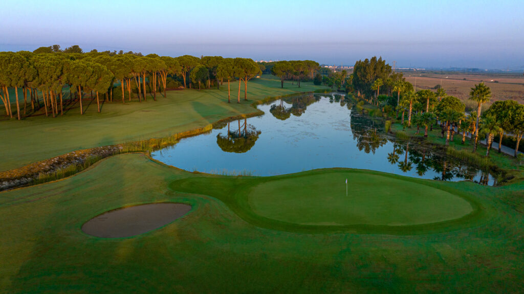 Lake on fairway with hole and trees in background at Gloria - Old Golf Course