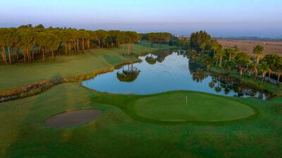 Lake on fairway with hole and trees in background at Gloria - Old Golf Course