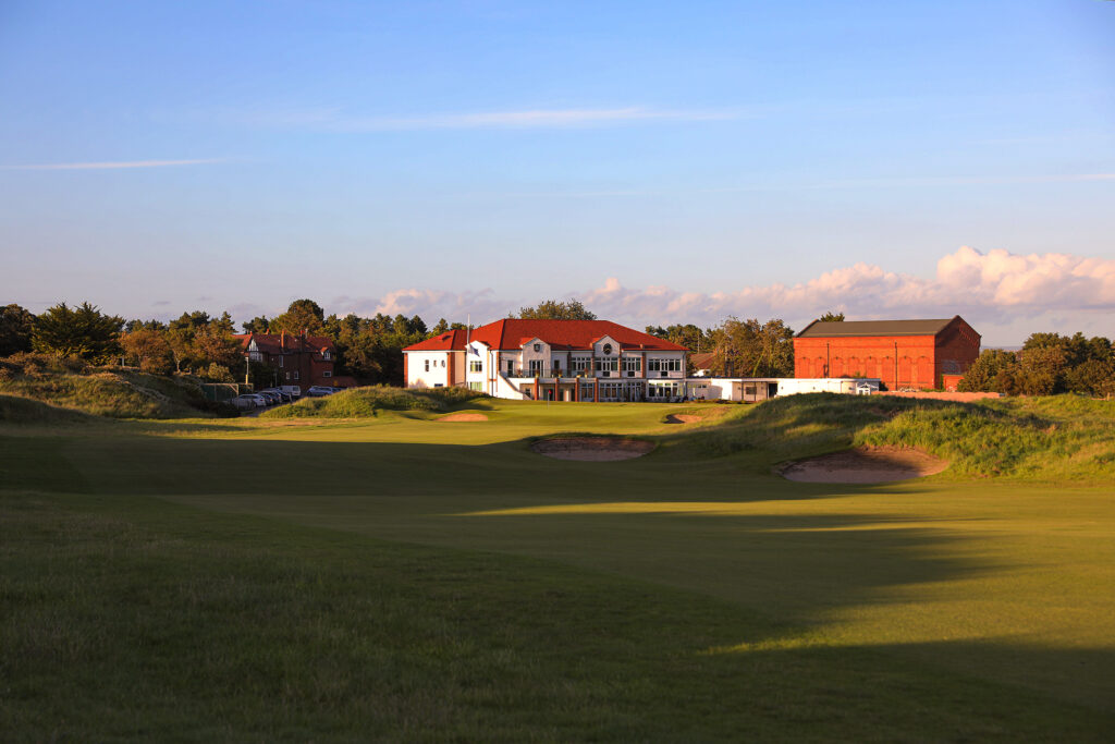 Fairway with bunkers with building in background at Hillside Golf Club