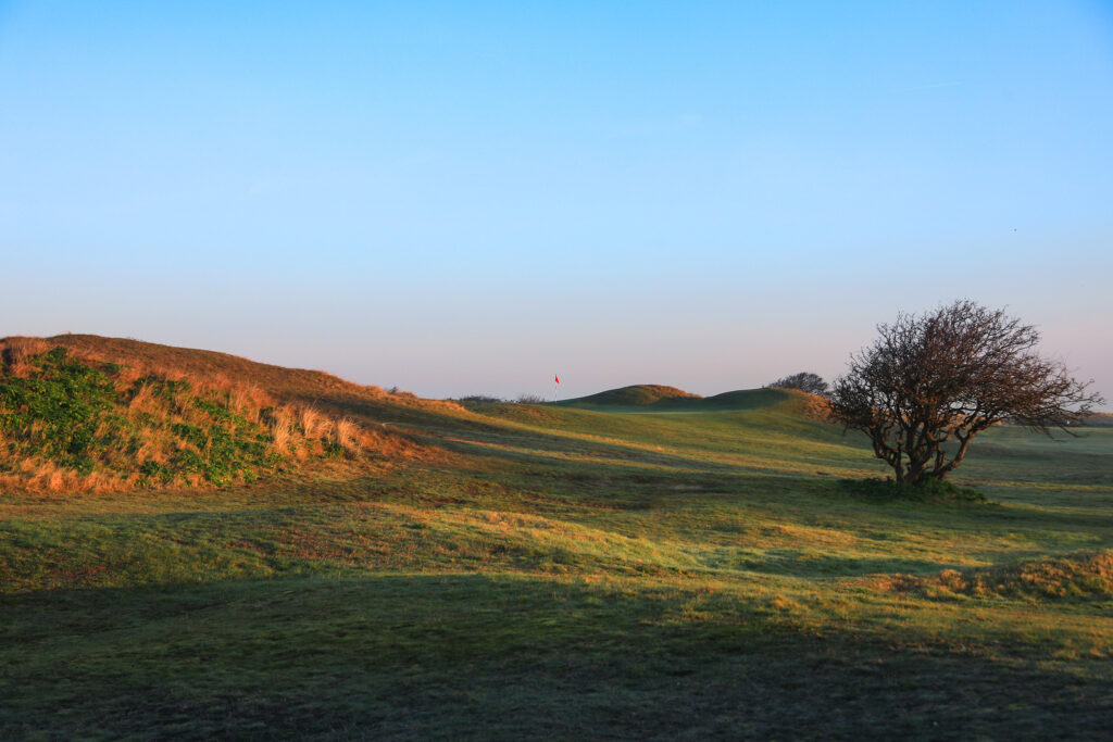 Fairway with hole with red flag at the top at Hunstanton Golf Club