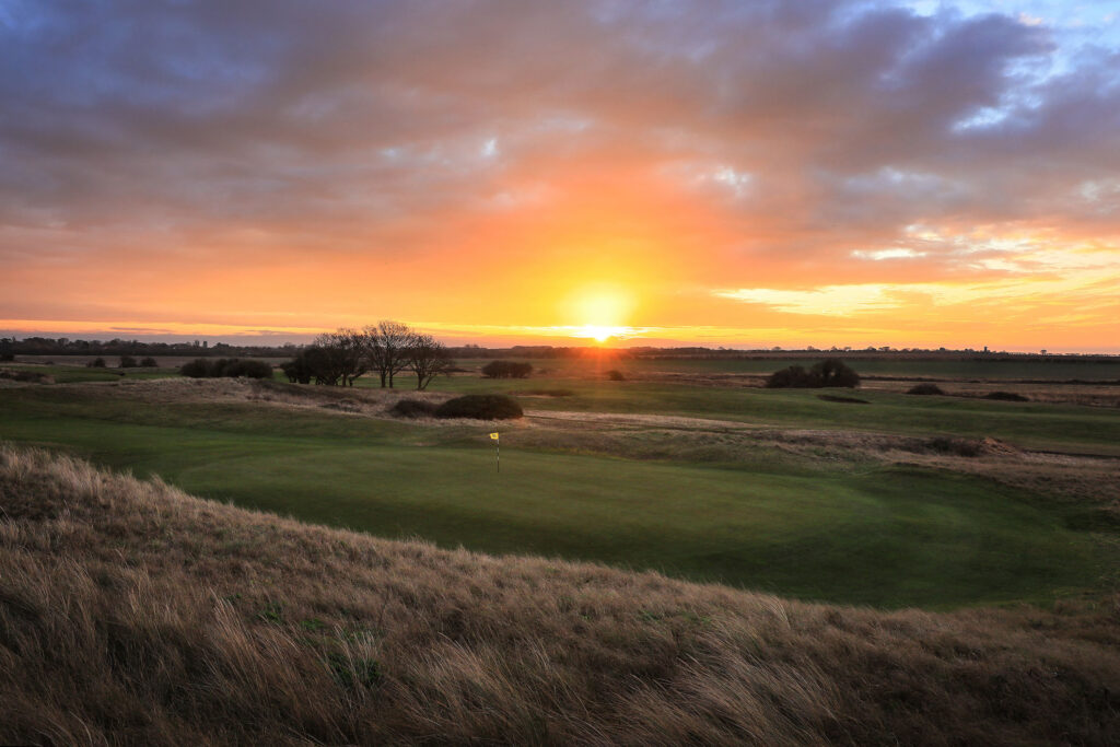 Hole with yellow flag at Hunstanton Golf Club at sunset