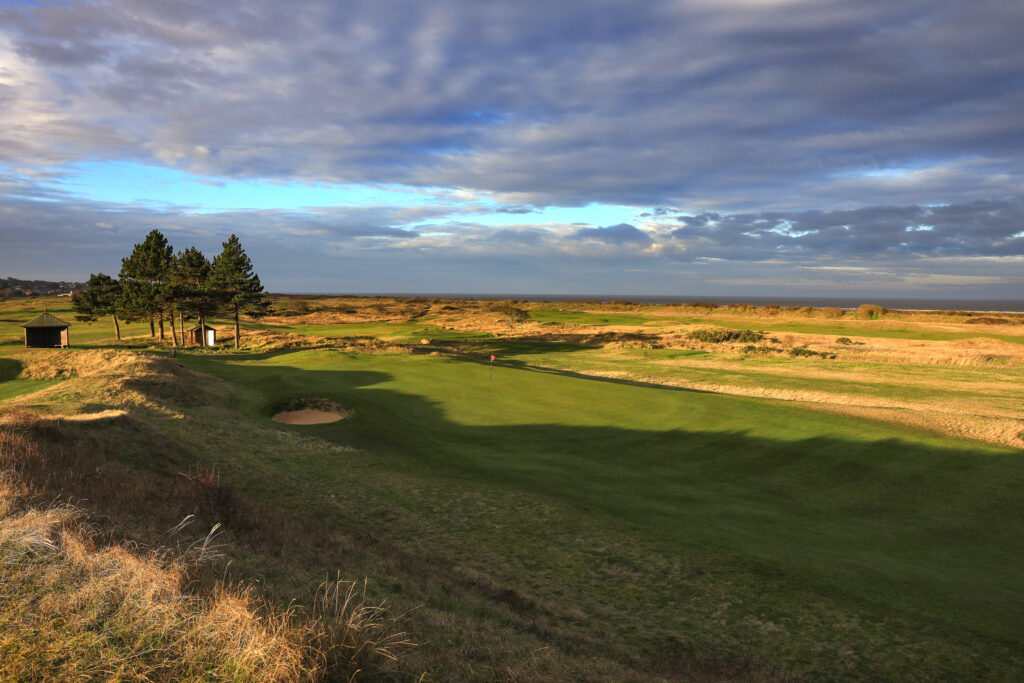 Aerial view of a hole with a red flag at Hunstanton Golf Club