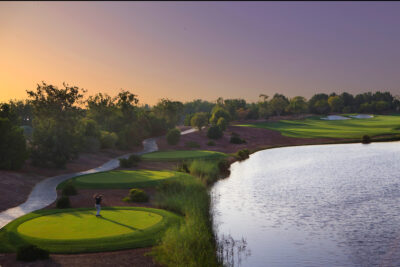 Tee box next to a lake at Jumeirah Golf Estates - Earth Course