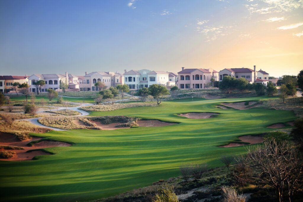 Bunkers on fairway at Jumeirah Golf Estates - Fire Course with buildings in distance