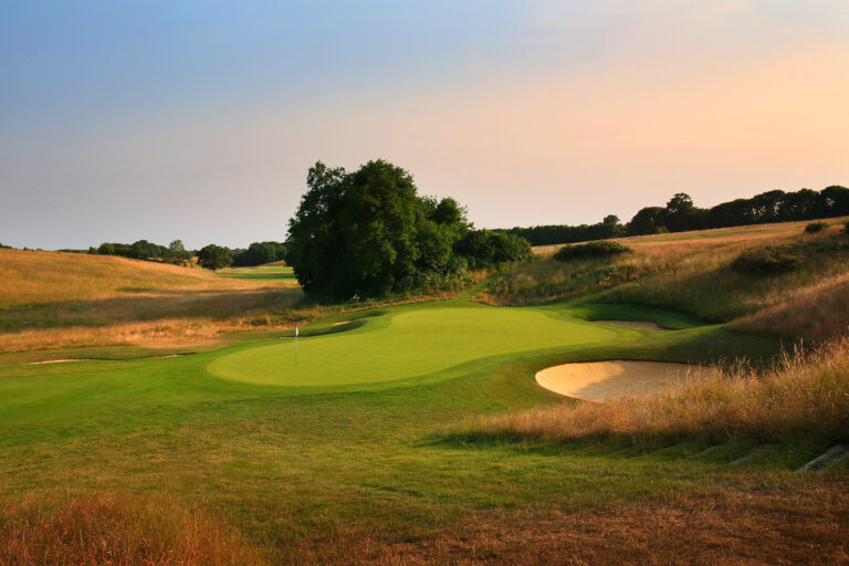 Hole with white flag with trees at The London Golf Club