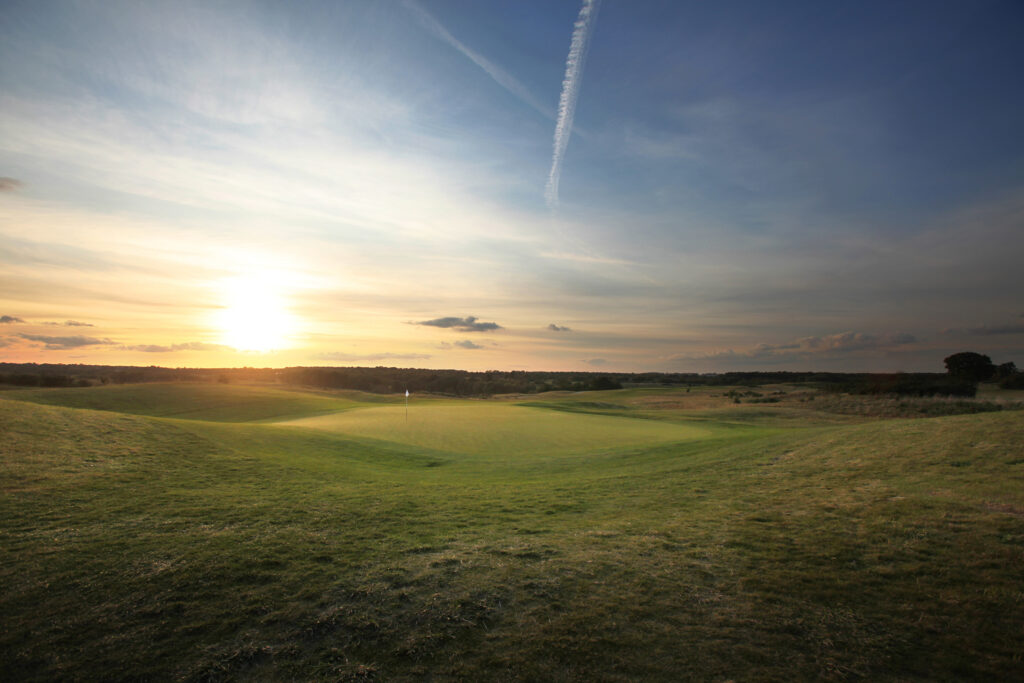 Hole with white flag with fairway around at The London Golf Club