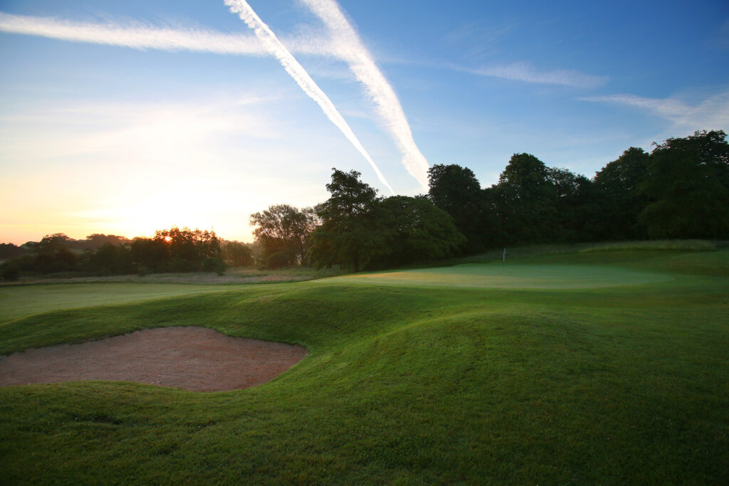 Hole with bunker and trees around at Mottram Hall Golf Course