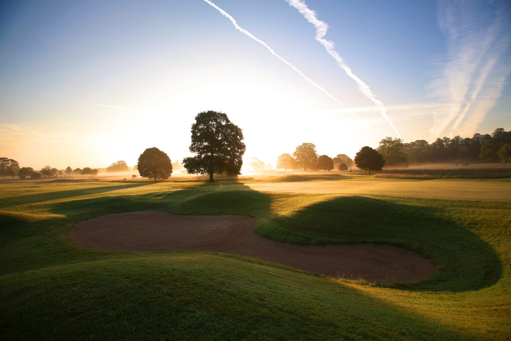 Hole with bunker and trees around at Mottram Hall Golf Course