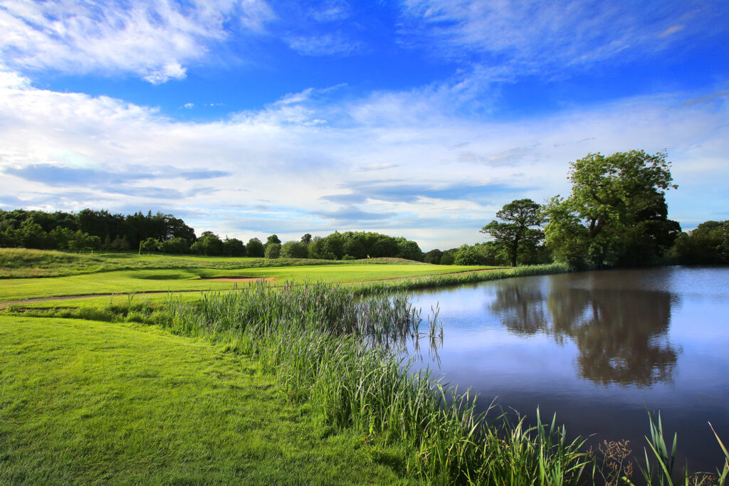 Lake on fairway at Oulton Hall Golf Club with trees around