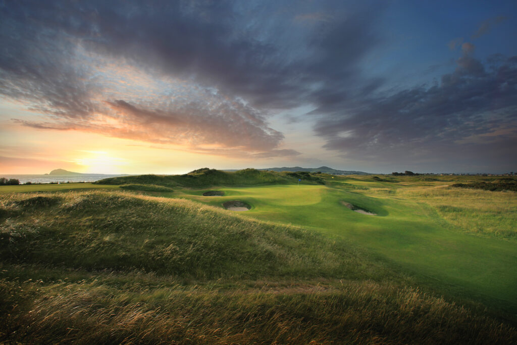 Hole with bunkers at Portmarnock Golf Club with mounds around