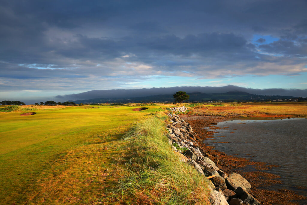 Bunkers on fairway at Portmarnock Golf Club with ocean next to it