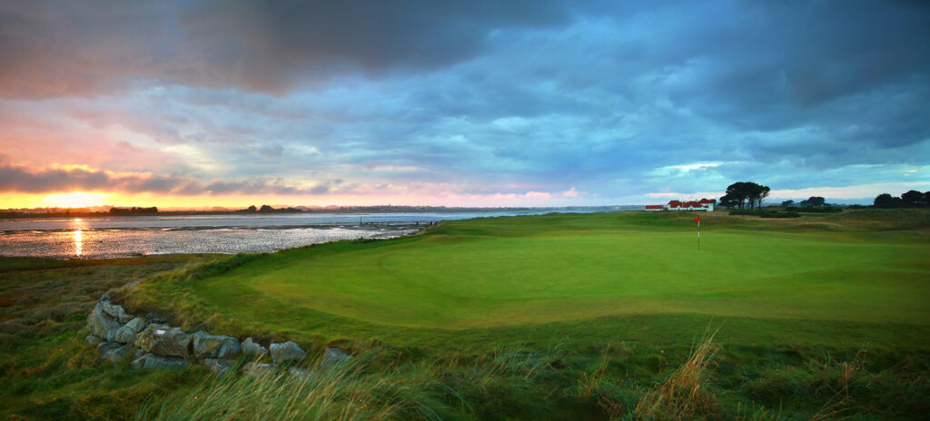 Hole with red flag with ocean view at Portmarnock Golf Club