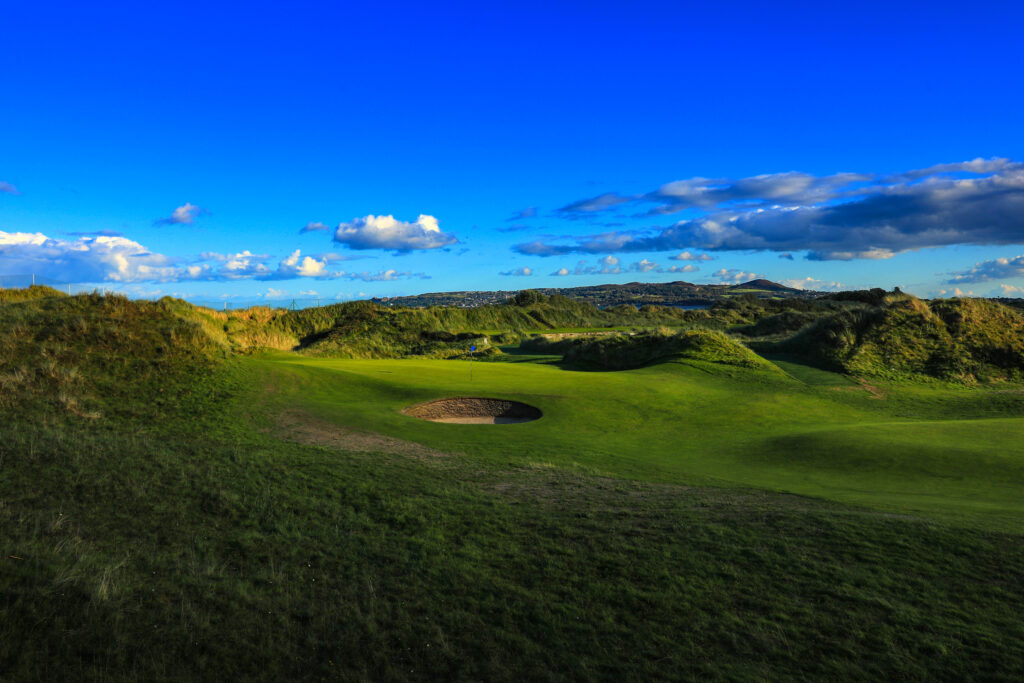 Hole with bunker at Portmarnock Golf Club with mounds around