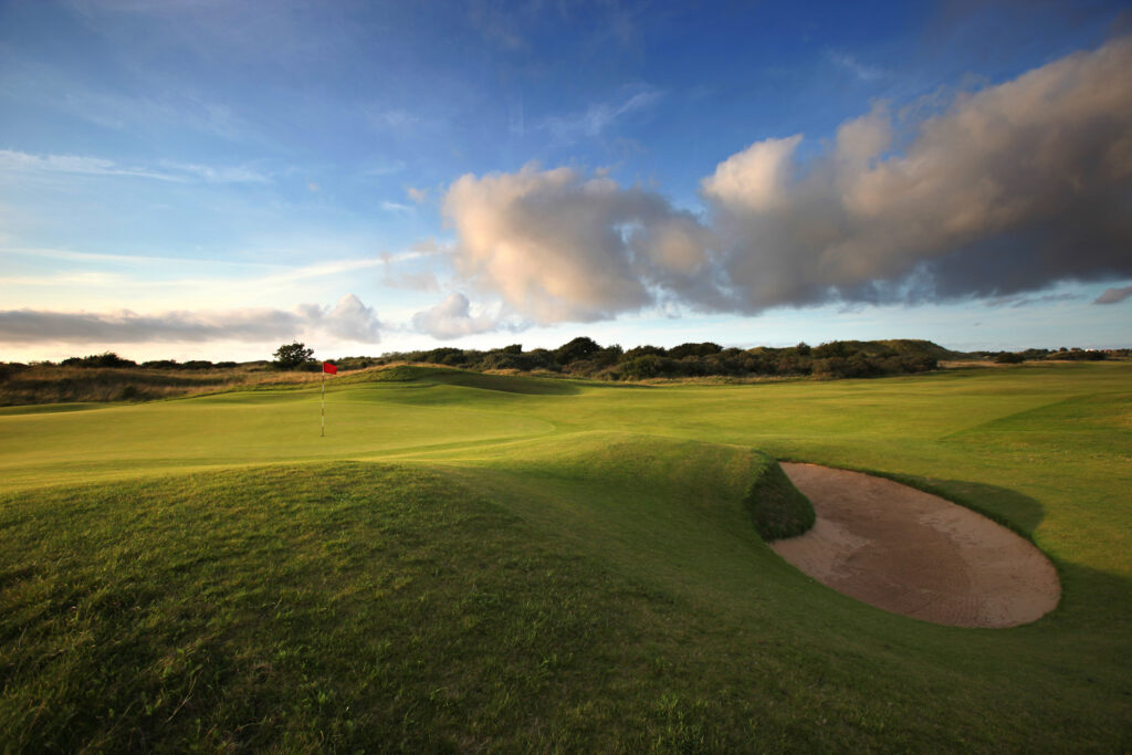 Hole with red flag with bunker at Royal Birkdale