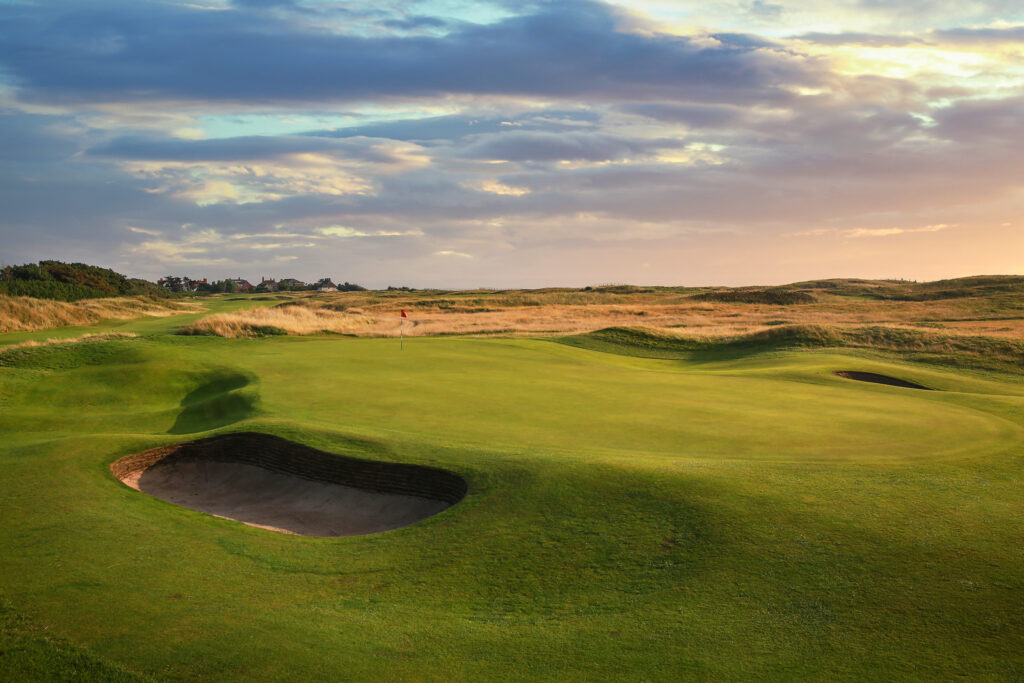 Hole with red flag with bunkers at Royal Liverpool Golf Club