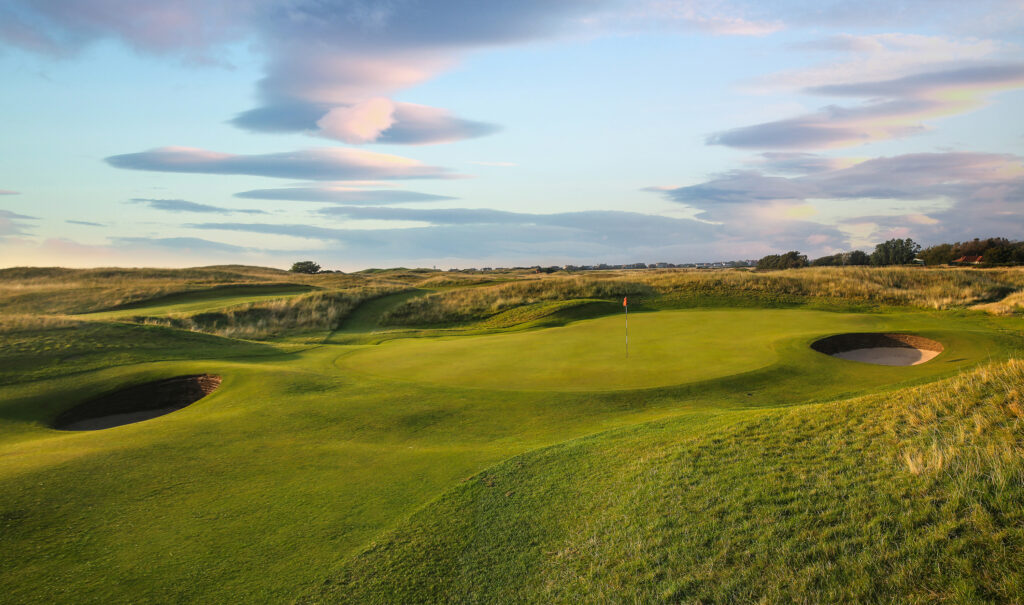 Hole with red flag and bunkers at Royal Liverpool Golf Club