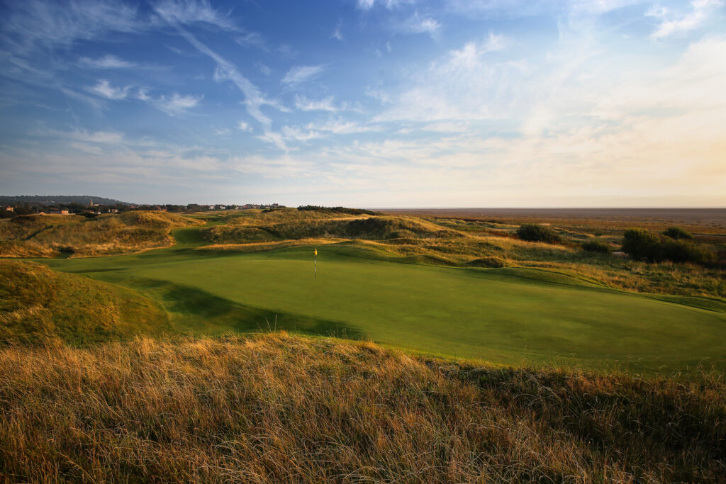 Hole with yellow flag at Royal Liverpool Golf Club