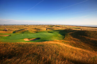 View of Royal St George's Golf Club with hole with white flag